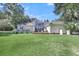 White house with a large deck, backyard, and mature trees at 3427 Colonel Vanderhorst Cir, Mount Pleasant, SC 29466