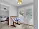 Charming home office with built-in shelves, a rocking chair, and French doors leading to balcony at 3427 Colonel Vanderhorst Cir, Mount Pleasant, SC 29466