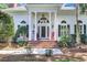 White house with a red rocking chair on the porch and brick steps at 3427 Colonel Vanderhorst Cir, Mount Pleasant, SC 29466