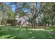 White house with a large lawn, mature trees, and a charming front porch at 3427 Colonel Vanderhorst Cir, Mount Pleasant, SC 29466