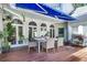 Relaxing patio with seating area, blue awning, and lush greenery at 3427 Colonel Vanderhorst Cir, Mount Pleasant, SC 29466