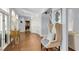 Light-filled hallway with hardwood floors and a comfortable wingback chair at 3427 Colonel Vanderhorst Cir, Mount Pleasant, SC 29466