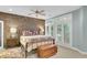 Bedroom with brick accent wall, metal bed frame, and plantation shutters at 3427 Colonel Vanderhorst Cir, Mount Pleasant, SC 29466