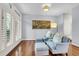 Light-filled sitting area with two armchairs and a wooden floor at 3427 Colonel Vanderhorst Cir, Mount Pleasant, SC 29466