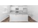 Kitchen boasts white cabinets, granite countertops and island with sink at 361 Willows Crescent Dr, Moncks Corner, SC 29461