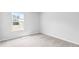 Well-lit bedroom featuring neutral walls, carpet flooring, and a window with a view at 361 Willows Crescent Dr, Moncks Corner, SC 29461