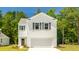 Two-story home with white siding, gray shutters, and a two-car garage at 353 Willows Crescent Way, Moncks Corner, SC 29461