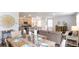 Bright dining area with farmhouse table and access to kitchen at 353 Willows Crescent Way, Moncks Corner, SC 29461