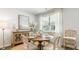 Bright dining room with a round table, four chairs, and a large window at 409 Peachwood Ln, Moncks Corner, SC 29461