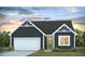 Two-story home with dark gray siding, white trim, and a green door at 409 Peachwood Ln, Moncks Corner, SC 29461