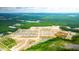 Aerial view of a new home community with houses, ponds, and green spaces at 188 Carolina Groves Blvd, Moncks Corner, SC 29461