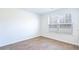 Simple bedroom with large window, wood-look flooring, and neutral walls at 180 Carolina Groves Blvd, Moncks Corner, SC 29461