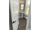 Powder room features pedestal sink, and dark gray tile flooring at 174 Whaler Ave, Summerville, SC 29486