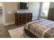 Bedroom with a dresser, TV, and view into the kitchen at 174 Whaler Ave, Summerville, SC 29486