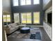 Spacious living room with large windows, hardwood floors, and a cozy sectional sofa at 174 Whaler Ave, Summerville, SC 29486