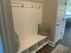 White bench with storage and hooks, ideal for an entryway at 174 Whaler Ave, Summerville, SC 29486