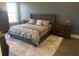 Spacious bedroom with a tufted headboard and large windows at 174 Whaler Ave, Summerville, SC 29486