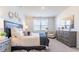 Main bedroom with king-size bed, dark wood furniture, and neutral decor at 162 Carolina Groves Blvd, Moncks Corner, SC 29461