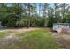 Overgrown backyard with shed and trailer at 316 Haynes St, Walterboro, SC 29488