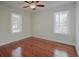 Spacious bedroom with hardwood floors and two windows at 316 Haynes St, Walterboro, SC 29488