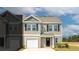 Two-story townhome with neutral siding and black shutters at 518 Golden Embers Way, Summerville, SC 29486