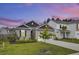 Beautiful home exterior at sunset, showcasing landscaping and driveway at 182 Greenwich Dr, Summerville, SC 29486