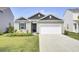 House exterior with a two-car garage and well maintained lawn at 182 Greenwich Dr, Summerville, SC 29486