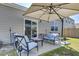 Backyard patio with seating area, umbrella, and a grassy lawn at 182 Greenwich Dr, Summerville, SC 29486