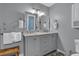 Double vanity bathroom with gray cabinets and marble countertop at 589 Oyster Rake Dr, Kiawah Island, SC 29455