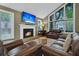 Living area with a fireplace, large windows and leather sofas at 589 Oyster Rake Dr, Kiawah Island, SC 29455