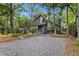 Gray house exterior with brick paver driveway and landscaping at 589 Oyster Rake Dr, Kiawah Island, SC 29455