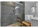 Walk-in shower with gray tile and pebble floor at 589 Oyster Rake Dr, Kiawah Island, SC 29455