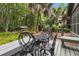Deck with wrought iron patio set and lush forest views at 589 Oyster Rake Dr, Kiawah Island, SC 29455