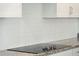 Modern glass cooktop with four burners, seamlessly integrated into granite countertop at 112 Archdale St St, Summerville, SC 29486