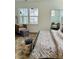 Main bedroom with a king-size bed, plush bedding, and a sitting area at 420 Carolina Cherry Ct # 204, Charleston, SC 29414
