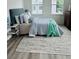 Charming bedroom with a queen-size bed, area rug, and a window with natural light at 420 Carolina Cherry Ct # 204, Charleston, SC 29414