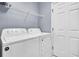 Laundry room with Whirlpool washer and dryer, and built-in shelving at 462 Eastern Isle Ave, Summerville, SC 29486