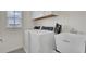 Bright laundry room features washer, dryer, and utility sink at 112 Whitetail Rd, Summerville, SC 29483