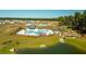 Aerial view of Carolina Groves community, featuring a pool, playground, and pond at 213 Blue Haw Dr, Moncks Corner, SC 29461