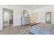 Bright bedroom with a cozy bed, built-in shelving, and access to another room at 420 Carolina Cherry Ct # 202, Charleston, SC 29414