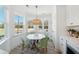 Bright kitchen nook with a round table and four green chairs, overlooking the backyard at 420 Carolina Cherry Ct # 202, Charleston, SC 29414