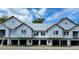 Three-unit building under construction, featuring contemporary design and attached garages at 420 Carolina Cherry Ct # 202, Charleston, SC 29414