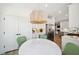 Kitchen nook features a marble table, green chairs, and a statement light fixture at 420 Carolina Cherry Ct # 202, Charleston, SC 29414