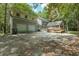 Two-story house with attached garage, deck, and surrounding trees at 200 Old Postern Rd, Summerville, SC 29483
