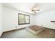 Empty bedroom with window, ceiling fan, and simple wooden platform bed frame at 200 Old Postern Rd, Summerville, SC 29483