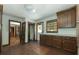 Retro kitchen features wood cabinets, laminate countertops, and wood flooring at 200 Old Postern Rd, Summerville, SC 29483