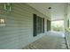 Covered front porch with wooden floors and white railings at 200 Old Postern Rd, Summerville, SC 29483