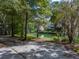 Long driveway leading to a house next to a pond at 200 Old Postern Rd, Summerville, SC 29483