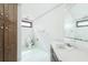 Dated bathroom with wood cabinets, striped wallpaper, and worn-out fixtures at 200 Old Postern Rd, Summerville, SC 29483