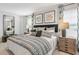 Main bedroom with king bed, sitting chair, and walk-in closet at 177 Carolina Groves Blvd, Moncks Corner, SC 29461